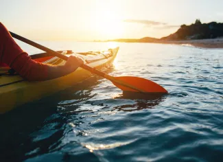 Close up of man holding kayak paddles