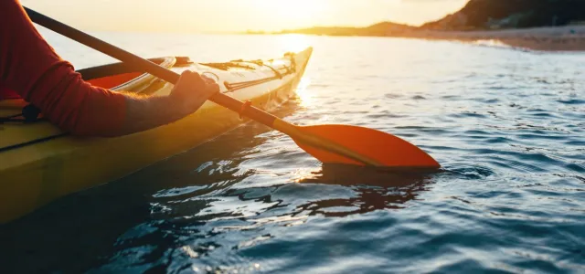 Close up of man holding kayak paddles
